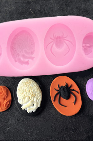 The skulls, spider and human heart silicone mould with examples below it.
